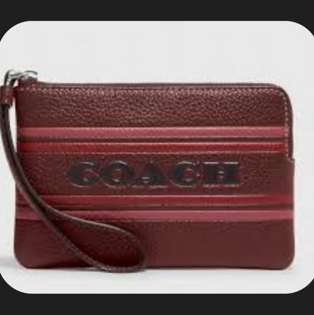 Coach Women's Corner Zip Wristlet with Coach Stripe in the color Wine Multi.